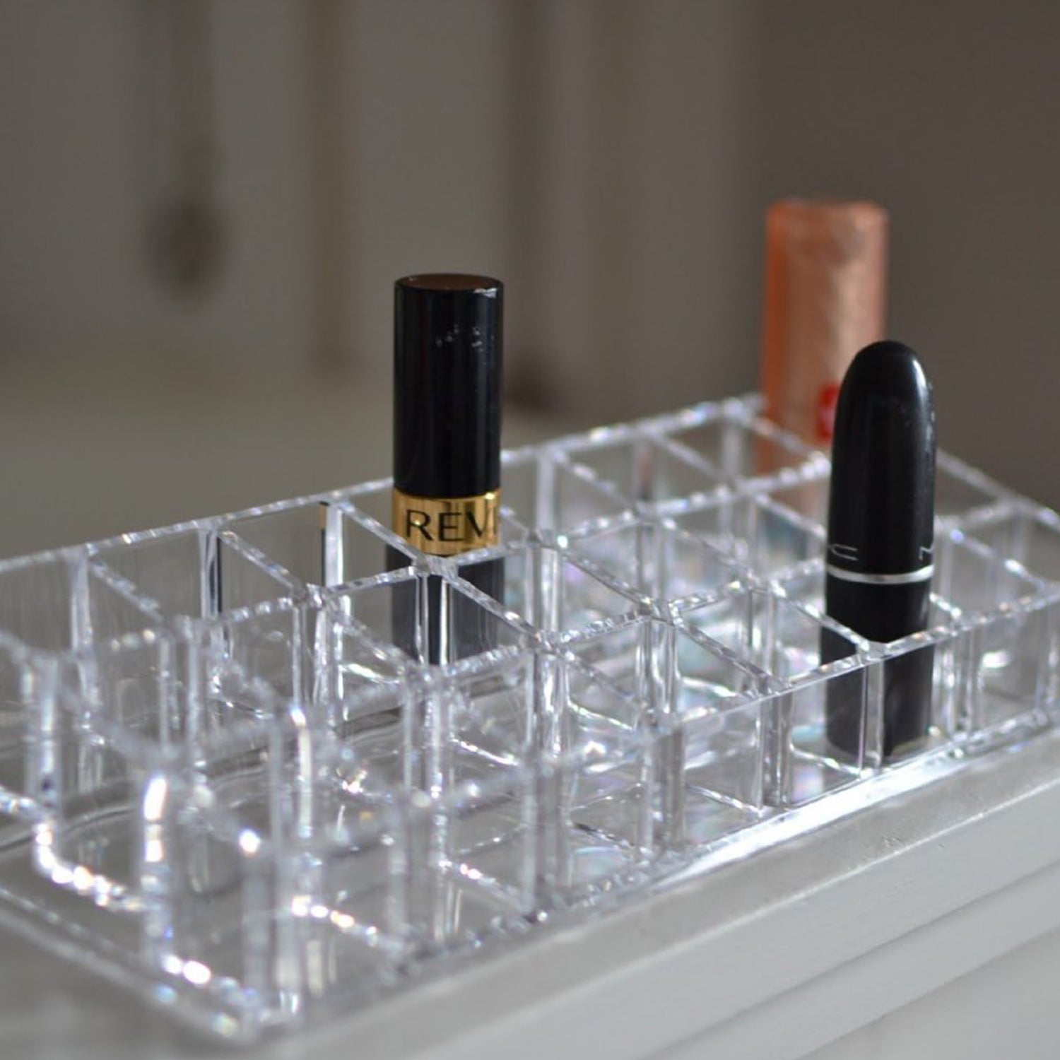 Close-up view of the acrylic lipstick holder, highlighting the clarity and design of the 24 sections Close-up view of the acrylic lipstick holder, highlighting the clarity and design of the 24 sections